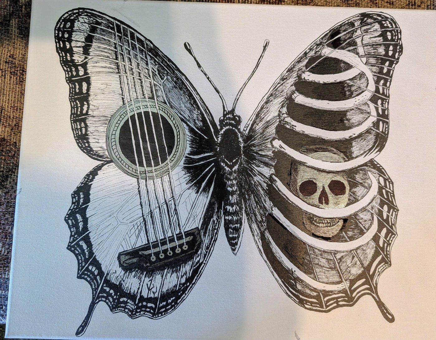 A butterfly whose left wing is a guitar and whose right wing is a ribcage with a skull inside