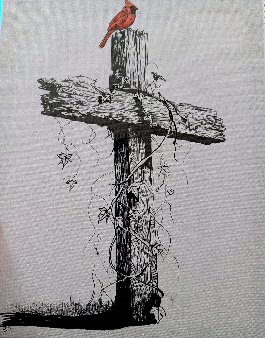 A weathered wooden cross wrapped in ivy with a single red cardinal perched on top