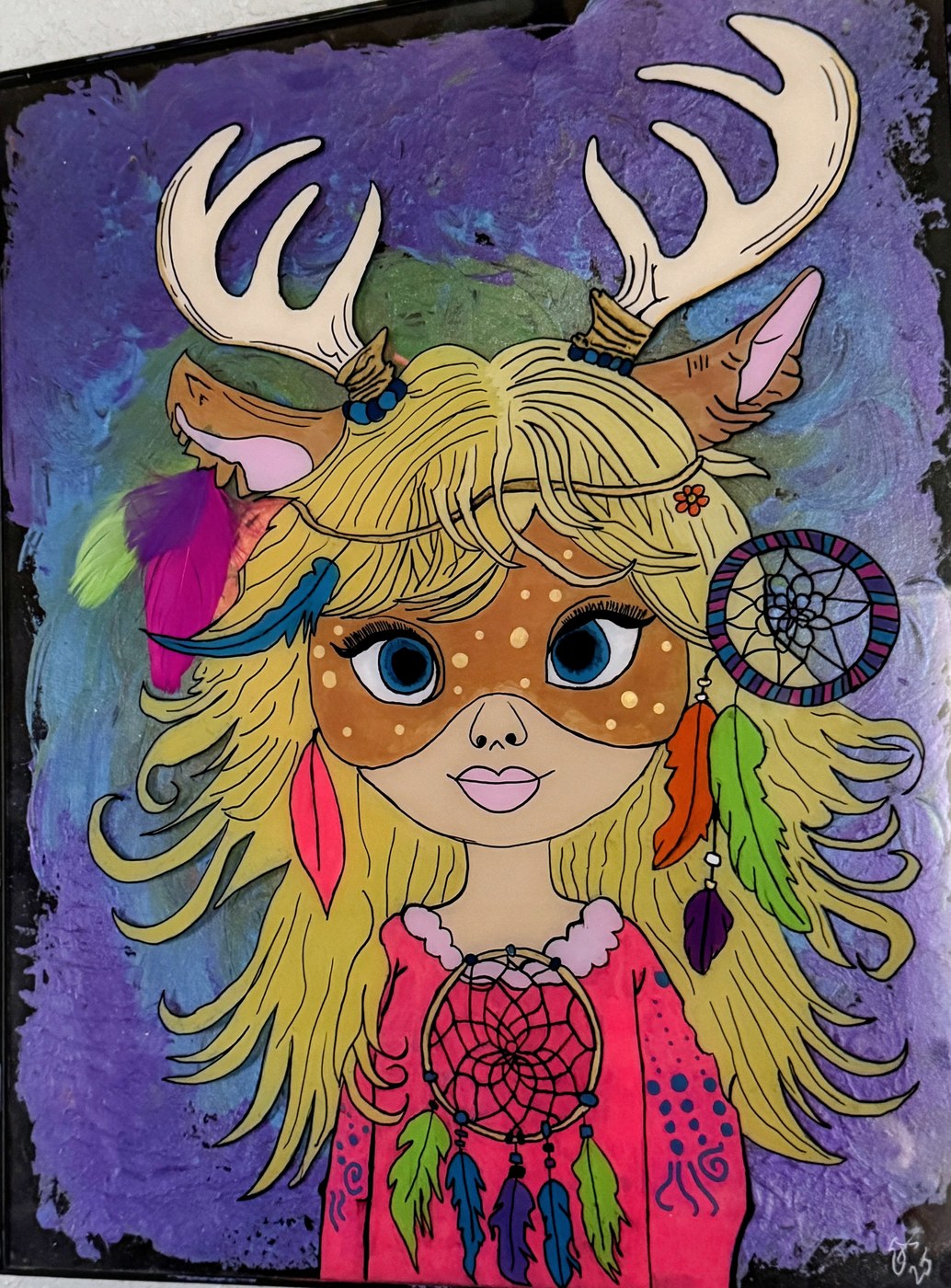 A big-eyed girl with deer antlers, feathers and dreamcatchers