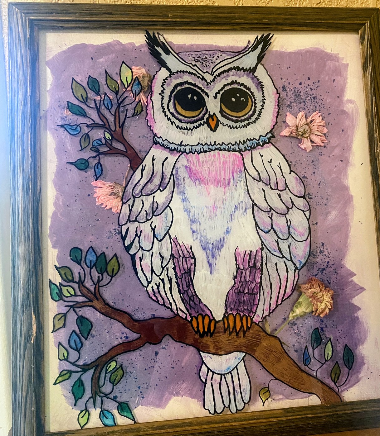 A soft purple owl on a branch with real pressed flowers set into the glass